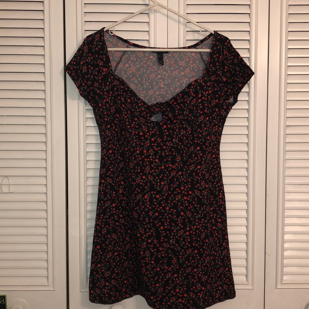 Selling a black dress with red flower detail
